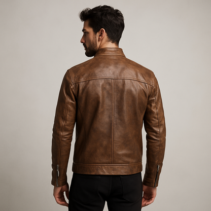 Man wearing a brown leather jacket against a plain background